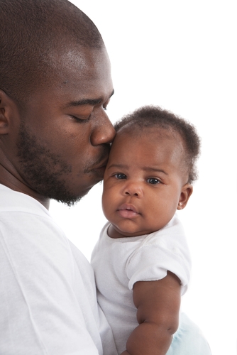 father kissing baby